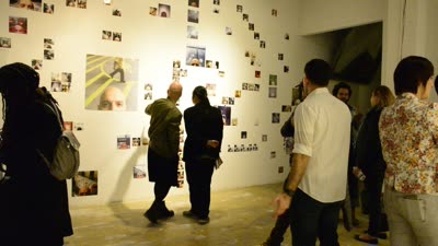 Visitors at the wall of photographs, 13 April 2016.