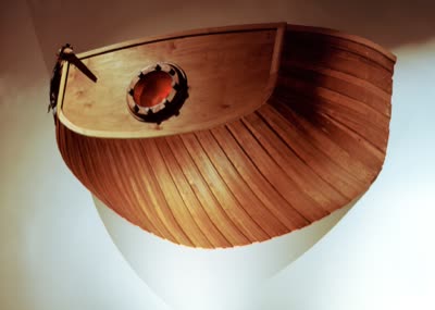 Te Foxl w/Skroo-I: the stern of a ship emerging through the gallery wall; visitors stepped up onto pulley blocks to look through the porthole, 2007.