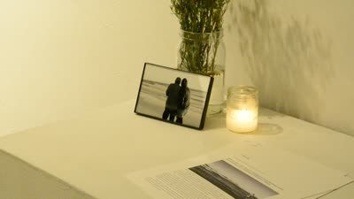 A framed photograph with a candle and flowers, 15 April 2016.