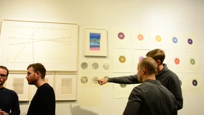 Visitors at a wall of drawings, 17 November 2015.