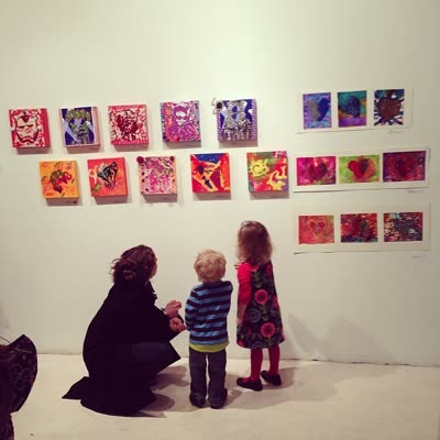 Students’ paintings on the wall at the opening, 6 March 2014.