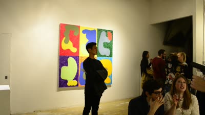 Visitors by a painting of colored shapes, 11 April 2016.