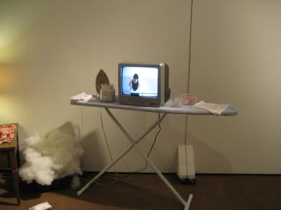 Installation with ironing board and television.