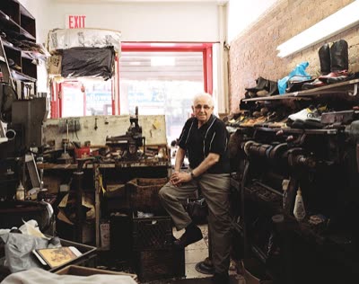 Lindsay Blatt, from Repair & Shine: shoe repairman seated among his machines, 2008, large-format photograph.