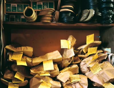 Lindsay Blatt, from Repair & Shine: repairs waiting in tagged paper bags, 2008, large-format photograph.