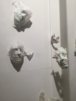 Wall installation of cast paper and plaster faces, 4 March 2016.