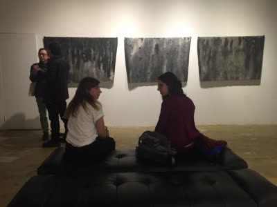Visitors in front of three large prints, 4 March 2016.