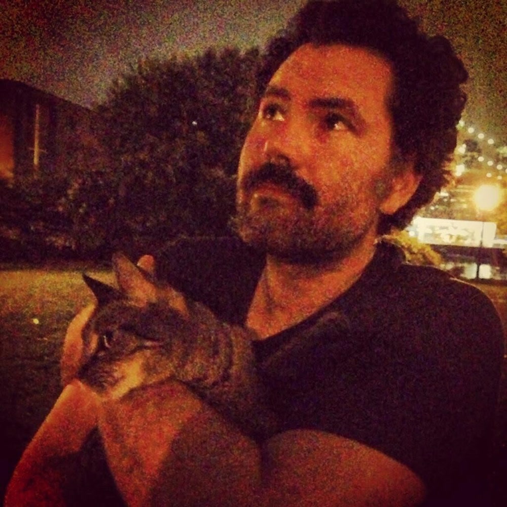 Shawn Lyons holding Maya outdoors at night in DUMBO